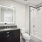 Bathroom with tub and lit mirror