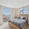 Bed with large floor to ceiling windows